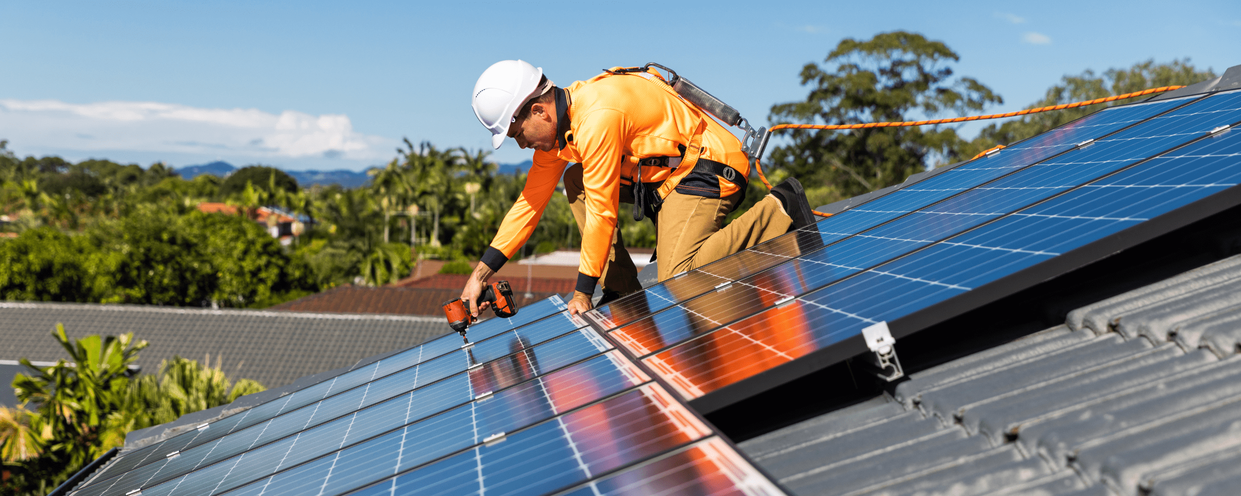 Installer fitting solar panels on a roof